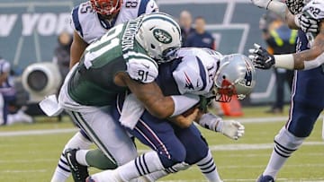 Dec 27, 2015; East Rutherford, NJ, USA; New York Jets defensive end Sheldon Richardson (91) sacks New England Patriots quarterback Tom Brady (12) during the fourth quarter at MetLife Stadium. New York Jets defeat the New England Patriots 26-20 in OT. Mandatory Credit: Jim O