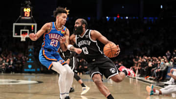 Jan 13, 2022; Brooklyn, New York, USA; Brooklyn Nets guard James Harden (13) drives past Oklahoma City Thunder guard Tre Mann (23) in the fourth quarter at Barclays Center. Mandatory Credit: Wendell Cruz-USA TODAY Sports