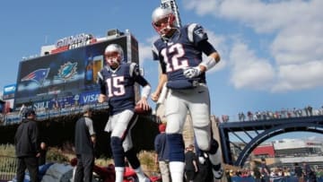 Oct 27, 2013; Foxborough, MA, USA; New England Patriots quarterback Tom Brady (12) and quarterback Ryan Mallett (15) take the field bebore their game against the Miami Dolphins at Gillette Stadium. Mandatory Credit: Winslow Townson-USA TODAY Sports