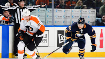 BUFFALO, NY - DECEMBER 8: Claude Giroux #28 of the Philadelphia Flyers controls the puck against Nathan Beaulieu #82 of the Buffalo Sabres during an NHL game on December 8, 2018 at KeyBank Center in Buffalo, New York. (Photo by Joe Hrycych/NHLI via Getty Images)