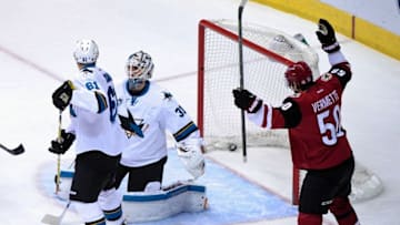 Mar 17, 2016; Glendale, AZ, USA; Arizona Coyotes defenseman Michael Stone (not pictured) scores on San Jose Sharks goalie Martin Jones (31) as defenseman Justin Braun (61) and Arizona center Antoine Vermette (50) look on during the first period at Gila River Arena. Mandatory Credit: Matt Kartozian-USA TODAY Sports