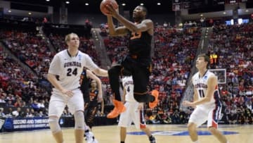 Mar 21, 2014; San Diego, CA, USA; Oklahoma State Cowboys guard Marcus Smart (33) shoots between Gonzaga Bulldogs center Przemek Karnowski (24) and guard David Stockton (11) in the first half of a men