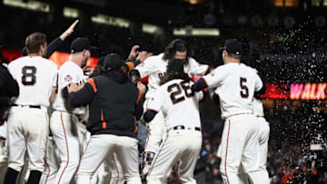 SAN FRANCISCO, CA - JUNE 27: Brandon Crawford #35 of the San Francisco Giants is congratulated by teammates after he hit a walk off home run in the ninth inning to beat the Colorado Rockies at AT&T Park on June 27, 2018 in San Francisco, California. (Photo by Ezra Shaw/Getty Images)