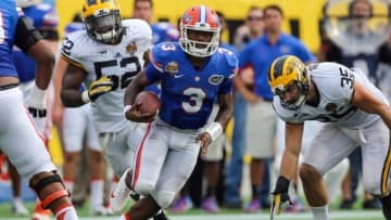 Jan 1, 2016; Orlando, FL, USA; Florida Gators quarterback Treon Harris (3) runs the ball against the Michigan Wolverines during the second quarter in the 2016 Citrus Bowl at Orlando Citrus Bowl Stadium. Mandatory Credit: Jim Dedmon-USA TODAY Sports