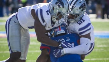 LAWRENCE, KS - OCTOBER 28: Kansas State Wildcats defensive back D.J. Reed (2) and Kansas State Wildcats defensive back Kendall Adams (21) tag team a Jayhawk during the game between the Kansas Jayhawks and the Kansas State Wildcats of Saturday October 28, 2017 at Memorial Stadium in Lawrence, KS. (Photo by Nick Tre. Smith/Icon Sportswire via Getty Images)