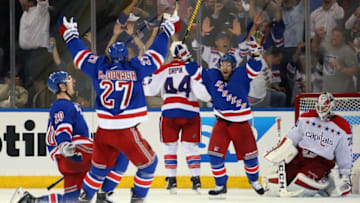 NEW YORK, NY - MAY 08: Chris Kreider #20 (l) celebrates his third period game tying goal against Braden Holtby #70 of the Washington Capitals and is joined by Ryan McDonagh #27 (c) and Martin St. Louis #26 of the New York Rangers in Game Five of the Eastern Conference Semifinals during the 2015 NHL Stanley Cup Playoffs at Madison Square Garden on May 8, 2015 in New York City. (Photo by Bruce Bennett/Getty Images)