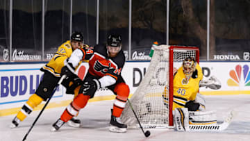 STATELINE, NEVADA - FEBRUARY 21: Sean Couturier #14 of the Philadelphia Flyers skates with the puck pressured by Patrice Bergeron #37 of the Boston Bruins during the 'NHL Outdoors At Lake Tahoe' at the Edgewood Tahoe Resort on February 21, 2021 in Stateline, Nevada. The Bruins defeated the Flyers 7-3. (Photo by Christian Petersen/Getty Images)
