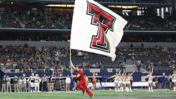 Nov 25, 2016; Arlington, TX, USA; A Texas Tech Red Raiders cheerleader runs with a flag before the game with the Baylor Bears at AT&T Stadium. Mandatory Credit: Michael C. Johnson-USA TODAY Sports