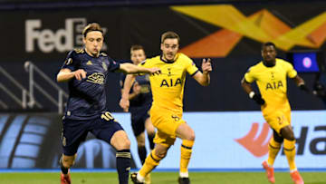 ZAGREB, CROATIA - MARCH 18: Lovro Majer of GNK Dinamo Zagreb runs with the ball whilst under pressure from Harry Winks of Tottenham Hotspur during the UEFA Europa League Round of 16 Second Leg match between Dinamo Zagreb and Tottenham Hotspur at Stadion Maksimir on March 18, 2021 in Zagreb, Croatia. Sporting stadiums around Europe remain under strict restrictions due to the Coronavirus Pandemic as Government social distancing laws prohibit fans inside venues resulting in games being played behind closed doors. (Photo by Jurij Kodrun/Getty Images)