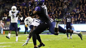 Oct 29, 2015; Fort Worth, TX, USA; TCU Horned Frogs wide receiver Kolby Listenbee (7) makes the catch in front of West Virginia Mountaineers cornerback Nana Kyeremeh (14) during the second half of a game at Amon G. Carter Stadium. TCU won 40-10. Mandatory Credit: Ray Carlin-USA TODAY Sports