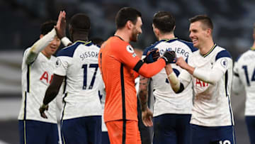 Tottenham Hotspur's Argentinian midfielder Giovani Lo Celso (R) reacts with Tottenham Hotspur's French goalkeeper Hugo Lloris (C) (Photo by NEIL HALL/POOL/AFP via Getty Images)