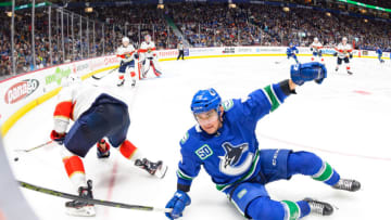 VANCOUVER, BC - OCTOBER 28: Vancouver Canucks Left Wing Micheal Ferland (79) is tripped up by Florida Panthers Defenceman Aaron Ekblad (5) during their NHL game at Rogers Arena on October 28, 2019 in Vancouver, British Columbia, Canada. (Photo by Derek Cain/Icon Sportswire via Getty Images)