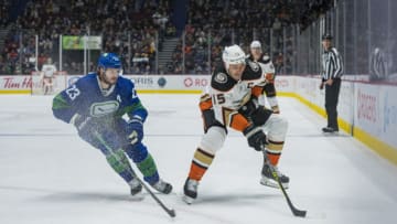 Nov 9, 2021; Vancouver, British Columbia, CAN; Vancouver Canucks defenseman Oliver Ekman-Larsson (23) checks Anaheim Ducks forward Ryan Getzlaf (15) in the second period at Rogers Arena. Mandatory Credit: Bob Frid-USA TODAY Sports