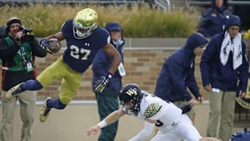SOUTH BEND, IN - NOVEMBER 04: Julian Love #27 of the Notre Dame Fighting Irish is knocked out of bound by John Wolford #10 of the Wake Forest Demon Deacons after an interception at Notre Dame Stadium on November 4, 2017 in South Bend, Indiana. (Photo by Jonathan Daniel/Getty Images)
