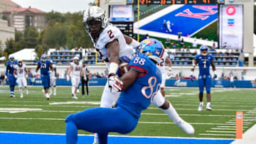 LAWRENCE, KS - SEPTEMBER 29: Wide receiver Jeremiah Booker #88 of the Kansas Jayhawks catches a touchdown pass against cornerback Tanner McCalister #2 of the Oklahoma State Cowboys in the fourth quarter at Memorial Stadium on September 29, 2018 in Lawrence, Kansas. (Photo by Ed Zurga/Getty Images)