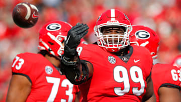 ATHENS, GA - NOVEMBER 20: Jordan Davis #99 of the Georgia Bulldogs reacts after rushing in for a touchdown during the first half against the Charleston Southern Buccaneers at Sanford Stadium on November 20, 2021 in Athens, Georgia. (Photo by Todd Kirkland/Getty Images)