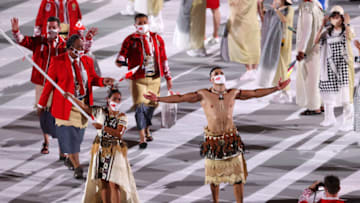 TOKYO, JAPAN - JULY 23: Flag bearers Malia Paseka and Pita Taufatofua of Team Tonga lead their team out during the Opening Ceremony of the Tokyo 2020 Olympic Games at Olympic Stadium on July 23, 2021 in Tokyo, Japan. (Photo by Patrick Smith/Getty Images)