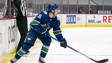 VANCOUVER, BC - FEBRUARY 13: Nils Hoglander #36 of the Vancouver Canucks skates with the puck during NHL hockey action against the Calgary Flames at Rogers Arena on February 13, 2021 in Vancouver, Canada. (Photo by Rich Lam/Getty Images)