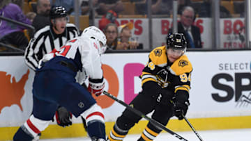 Sep 16, 2018; Boston, MA, USA; Washington Capitals defenseman Aarion Ness battles for the puck with Boston Bruins forward Jakub Lauko (94) during the first period at TD Garden. Mandatory Credit: Bob DeChiara-USA TODAY Sports