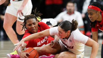 Louisville Cardinals Mykasa Robinson fights for ball with Cincinnati Bearcats A'riel Jackson during game at the KFC Yum Center. The Courier-Journal.
