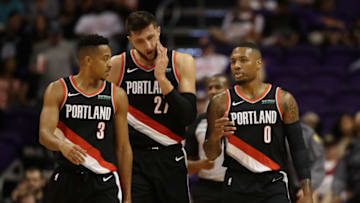 PHOENIX, AZ - OCTOBER 05: Damian Lillard #0 (R) of the Portland Trail Blazers talks with CJ McCollum #3 and Jusuf Nurkic #27 during the first half of the NBA preseason game against the Phoenix Suns at Talking Stick Resort Arena on October 5, 2018 in Phoenix, Arizona. NOTE TO USER: User expressly acknowledges and agrees that, by downloading and or using this photograph, User is consenting to the terms and conditions of the Getty Images License Agreement. (Photo by Christian Petersen/Getty Images)