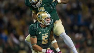 Oct 19, 2013; Waco, TX, USA; Baylor Bears linebacker Eddie Lackey (5) and defensive end Shawn Oakman (2) celebrate a sack during the game against the Iowa State Cyclones at Floyd Casey Stadium. The Bears defeated the Cyclones 71-7. Mandatory Credit: Jerome Miron-USA TODAY Sports
