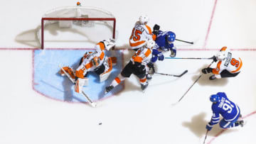 TORONTO, ON - NOVEMBER 9: Trevor Moore #42 of the Toronto Maple Leafs battles against Carsen Twarynski #81 of the Philadelphia Flyers and Matt Niskanen #15 in front of Brian Elliott #37 during the third period at the Scotiabank Arena on November 9, 2019 in Toronto, Ontario, Canada. (Photo by Mark Blinch/NHLI via Getty Images)