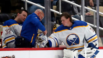 Sep 28, 2023; Pittsburgh, Pennsylvania, USA; Buffalo Sabres goaltender Eric Comrie (31) has his helmet repaired during a time-out against the Pittsburgh Penguins in the first period at PPG Paints Arena. Mandatory Credit: Charles LeClaire-USA TODAY Sports