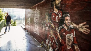 An Egyptian walks along a pedestrian crossing beneath a bridge in the Nile of island of Zamalek in the heart of the capital Cairo on September 5, 2018, towards a graffiti mural depicting players of the national football team and its star and Liverpool FC striker Mohamed Salah (C). - Mohamed Salah, back in Egypt for African Cup of Nations qualifiers, has already scored a victory, forcing his national football federation to back down after a war of nerves. (Photo by Mohamed el-Shahed / AFP) (Photo credit should read MOHAMED EL-SHAHED/AFP/Getty Images)