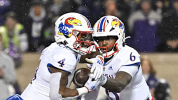 MANHATTAN, KS - NOVEMBER 26: Quarterback Jalon Daniels #6 of the Kansas Jayhawks hands the ball off to running back Devin Neal #4 during the first half against the Kansas State Wildcats at Bill Snyder Family Football Stadium on November 26, 2022 in Manhattan, Kansas. (Photo by Peter G. Aiken/Getty Images)