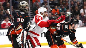 ANAHEIM, CALIFORNIA - NOVEMBER 12: Andreas Athanasiou #72 of the Detroit Red Wings pushes Jacob Larsson #32 as Ryan Miller #30 of the Anaheim Ducks looks on during the second period of a game at Honda Center on November 12, 2019 in Anaheim, California. (Photo by Sean M. Haffey/Getty Images)