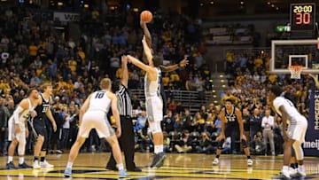 MILWAUKEE, WI - DECEMBER 27: Matt Heldt #12 of the Marquette Golden Eagles and Tyrique Jones #0 of the Xavier Musketeers jump for the ball to start a game at the BMO Harris Bradley Center on December 27, 2017 in Milwaukee, Wisconsin. (Photo by Stacy Revere/Getty Images)