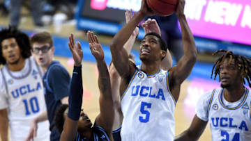 LOS ANGELES, CA - DECEMBER 09: Chris Smith #5 of the UCLA Bruins goes up for a basket over Frankie Hughes #3 of the San Diego Toreros in the second half of the game at Pauley Pavilion on December 9, 2020 in Los Angeles, California. (Photo by Jayne Kamin-Oncea/Getty Images)