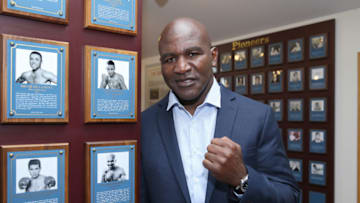 CANASTOTA, NY - JUNE 11: Boxing champion Evander Holyfield poses beside his plaque during the International Boxing Hall of Fame induction Weekend of Champions event on June 11, 2017 in Canastota, New York. (Photo by Alex Menendez/Getty Images)