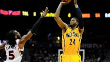 Apr 26, 2014; Atlanta, GA, USA; Indiana Pacers forward Paul George (24) shoots over Atlanta Hawks forward DeMarre Carroll (5) during the second half in game four of the first round of the 2014 NBA Playoffs at Philips Arena. The Pacers defeated the Hawks 91-88. Mandatory Credit: Dale Zanine-USA TODAY Sports