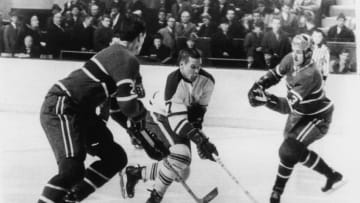 Canadian hockey player Tim Horton (center) of the Toronto Maple Leafs skates between Jacques Laperriere (#2) and Jean Claude Trembly (#3), both of the Montreal Canadiens, during a game in Montreal, Quebec, Canada, February 1, 1967. (Photo by Bruce Bennett Studios via Getty Images Studios/Getty Images)