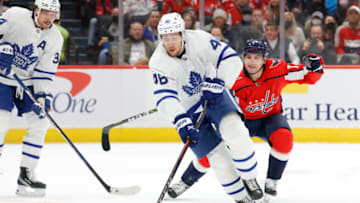 Feb 28, 2022; Washington, District of Columbia, USA; Toronto Maple Leafs defenseman Ilya Lyubushkin (46) skates with the puck as Washington Capitals left wing Conor Sheary (73) chases in the first period at Capital One Arena. Mandatory Credit: Geoff Burke-USA TODAY Sports