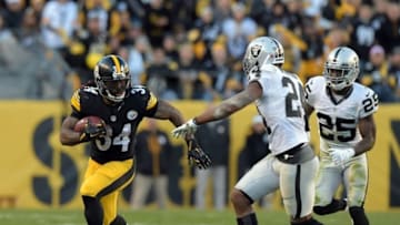 Nov 8, 2015; Pittsburgh, PA, USA; Pittsburgh Steelers running back Deangelo Williams (34) is pursued by Oakland Raiders safety Charles Woodson (24) and cornerback D.J. Hayden (25) in a NFL football game against the Oakland Raiders at Heinz Field. Mandatory Credit: Kirby Lee-USA TODAY Sports