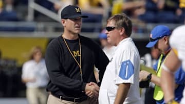 Jan 1, 2016; Orlando, FL, USA; Michigan Wolverines head coach Jim Harbaugh (left) and Florida Gators head coach Jim McElwain meet at midfield before the 2016 Citrus Bowl at Orlando Citrus Bowl Stadium. Mandatory Credit: Reinhold Matay-USA TODAY Sports