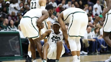 EAST LANSING, MI - NOVEMBER 30: Joshua Langford #1 and Xavier Tilman #23 of the Michigan State Spartans helps Cassius Winston #5 of the Michigan State Spartans off the floor during the game against the Notre Dame Fighting Irish at Breslin Center on November 30, 2017 in East Lansing, Michigan. (Photo by Rey Del Rio/Getty Images)