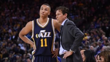 November 21, 2014; Oakland, CA, USA; Utah Jazz guard Dante Exum (11) and head coach Quin Snyder (right) talk during the first quarter against the Golden State Warriors at Oracle Arena. The Warriors defeated the Jazz 101-88. Mandatory Credit: Kyle Terada-USA TODAY Sports
