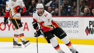 VANCOUVER, BC - FEBRUARY 08: T.J. Brodie #7 of the Calgary Flames skates with the puck in NHL action against the Vancouver Canucks at Rogers Arena on February 8, 2020 in Vancouver, Canada. (Photo by Rich Lam/Getty Images)