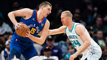 CHARLOTTE, NORTH CAROLINA - MARCH 28: Mason Plumlee #24 of the Charlotte Hornets guards Nikola Jokic #15 of the Denver Nuggets in the first quarter at Spectrum Center on March 28, 2022 in Charlotte, North Carolina. NOTE TO USER: User expressly acknowledges and agrees that, by downloading and or using this photograph, User is consenting to the terms and conditions of the Getty Images License Agreement. (Photo by Jacob Kupferman/Getty Images)