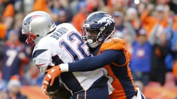 Jan 24, 2016; Denver, CO, USA; New England Patriots quarterback Tom Brady (12) is tackled by Denver Broncos outside linebacker Von Miller (58) in the third quarter in the AFC Championship football game at Sports Authority Field at Mile High. Mandatory Credit: Kevin Jairaj-USA TODAY Sports