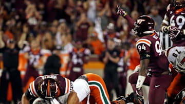 Oct 20, 2016; Blacksburg, VA, USA; Virginia Tech Hokies defensive lineman Vinny Mihota (99) and defensive end Trevon Hill (94) reacts after sacking Miami Hurricanes quarterback Brad Kaaya (15) during the fourth quarter at Lane Stadium. Mandatory Credit: Peter Casey-USA TODAY Sports