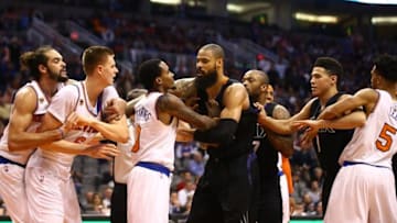 Dec 13, 2016; Phoenix, AZ, USA; (From left) New York Knicks center Joakim Noah holds back forward Kristaps Porzingis as guard Brandon Jennings pushes Phoenix Suns center Tyson Chandler as guard Devin Booker comes in during a third quarter fight at Talking Stick Resort Arena. Mandatory Credit: Mark J. Rebilas-USA TODAY Sports