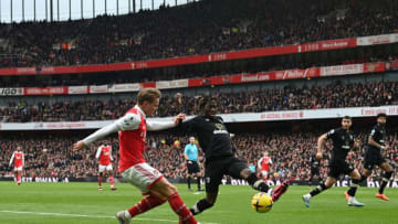 Arsenal's Norwegian midfielder Martin Odegaard (L) fights for the ball with Bournemouth's English defender Jordan Zemura during the English Premier League football match between Arsenal and Bournemouth at the Emirates Stadium in London on March 4, 2023. (Photo by Glyn KIRK / AFP) / RESTRICTED TO EDITORIAL USE. No use with unauthorized audio, video, data, fixture lists, club/league logos or 'live' services. Online in-match use limited to 120 images. An additional 40 images may be used in extra time. No video emulation. Social media in-match use limited to 120 images. An additional 40 images may be used in extra time. No use in betting publications, games or single club/league/player publications. / (Photo by GLYN KIRK/AFP via Getty Images)
