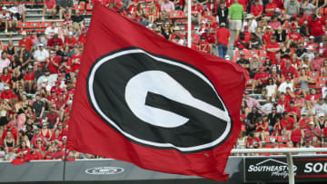 ATHENS, GA - SEPTEMBER 11: Cheerleaders run the Georgia Bulldogs flag after a score against the UAB Blazers in the second half at Sanford Stadium on September 11, 2021 in Athens, Georgia. (Photo by Brett Davis/Getty Images)