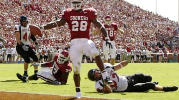 NORMAN, OK - OCTOBER 2: Freshman running back Adrian Peterson #28 of the Oklahoma Sooners slips into the endzone with only one shoe for a touchdown against the Texas Tech Red Raiders in the first quarter on October 2, 2004 at Memorial Stadium in Norman, Oklahoma. Peterson set up the play with a 64-yard run in Oklahoma's 28-13 win. (Photo by Brian Bahr/Getty Images)