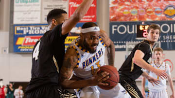 BAKERSFIELD, CA - DECEMBER 09: Cal State Bakersfield Roadrunners forward Shon Briggs (13) drive the ball into the basket against Idaho Vandals forward Brayon Blake (4) during the game between the Idaho Vandals and the CSUB Roadrunners on December 09, 2017, at Icardo Center in Bakersfield, CA.(Photo by David Dennis/Icon Sportswire via Getty Images)